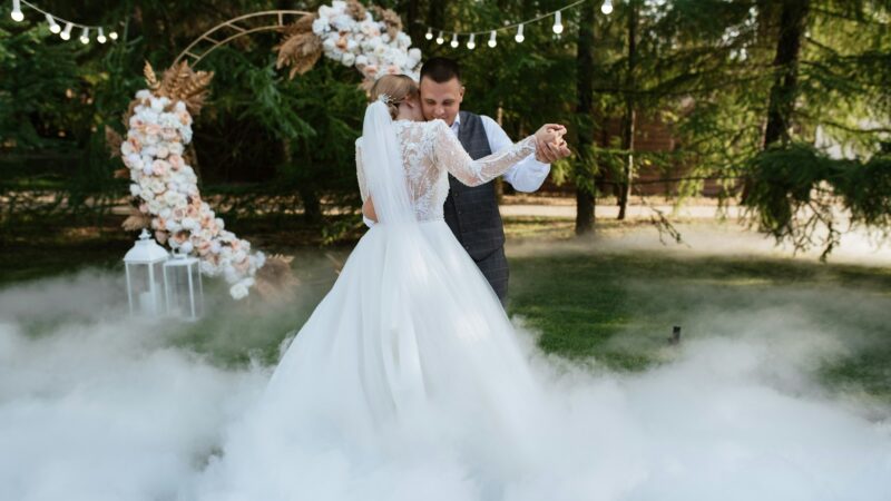 the first wedding dance of the bride and groom on a green meadow