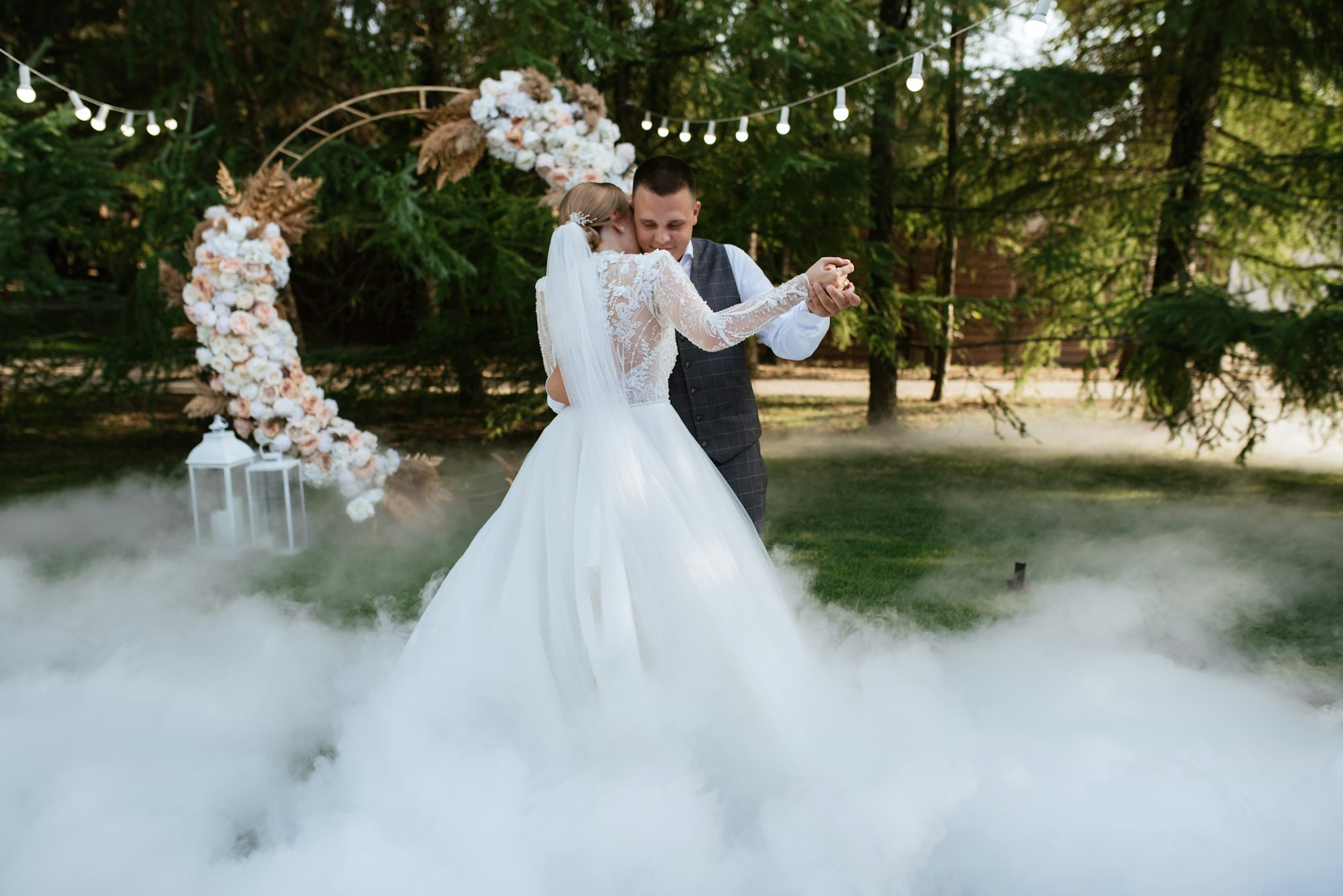 the first wedding dance of the bride and groom on a green meadow
